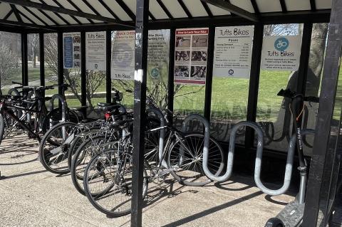 Several bicycles locked to a covered rack