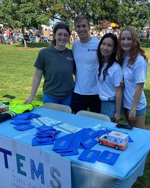 TEMS members standing at a booth on the Tufts campus