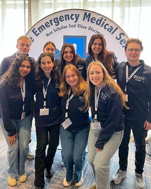 TEMS students standing today near a Emergency Medical Services sign