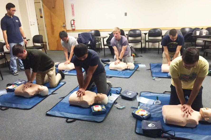 Student doing CPR on dummy bodies